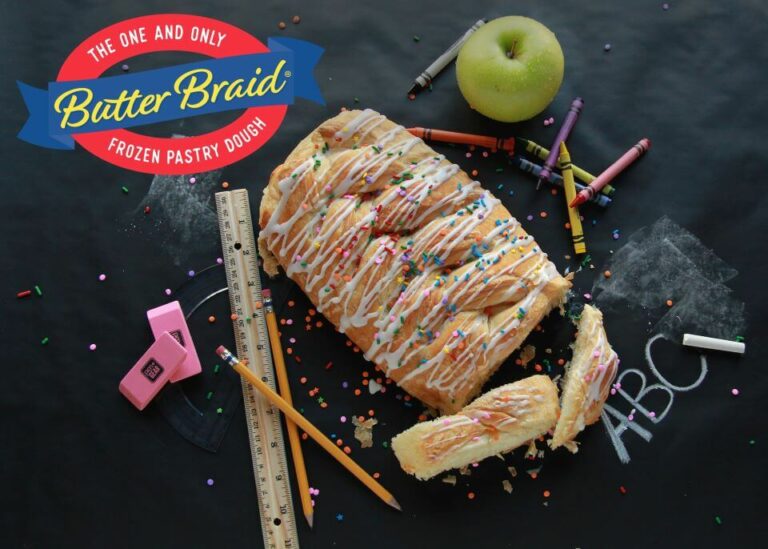 Butter braid pastry on blackboard with school supplies